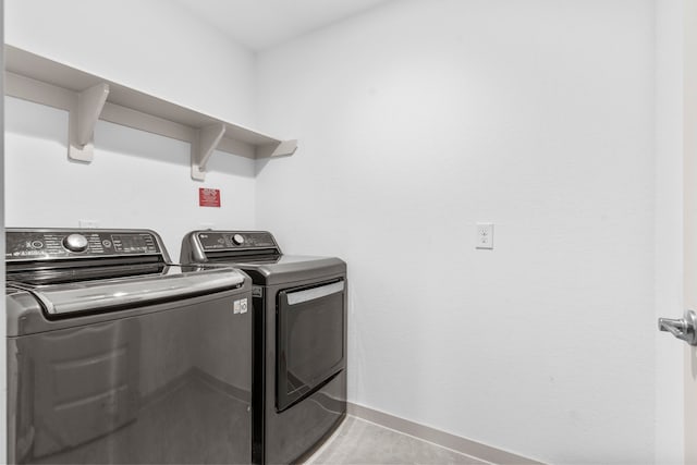 7414 Keystone Blossom Trl, Richmond, TX 77407 - washroom with washer and clothes dryer, baseboards, and light tile patterned flooring