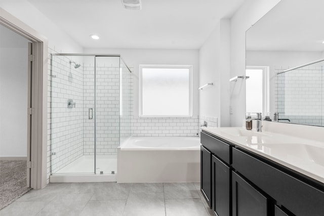 7414 Keystone Blossom Trl, Richmond, TX 77407 - full bath featuring a garden tub, a shower stall, double vanity, and tile patterned flooring