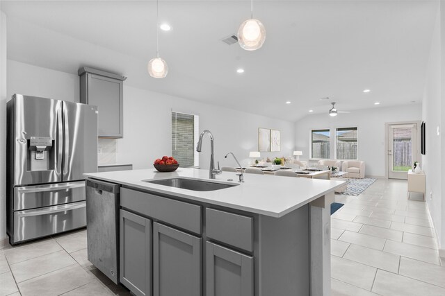 7414 Keystone Blossom Trl, Richmond, TX 77407 - kitchen with stainless steel appliances, gray cabinetry, a sink, light tile patterned floors, and light countertops