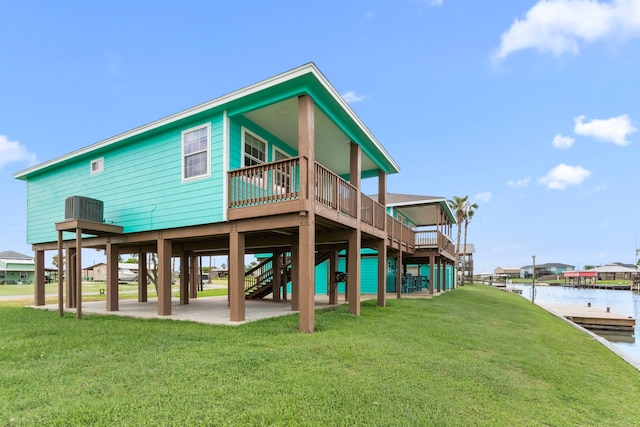 621 County Road 202, Sargent, TX 77414 - rear view of property featuring a yard, a deck with water view, a carport, and central AC