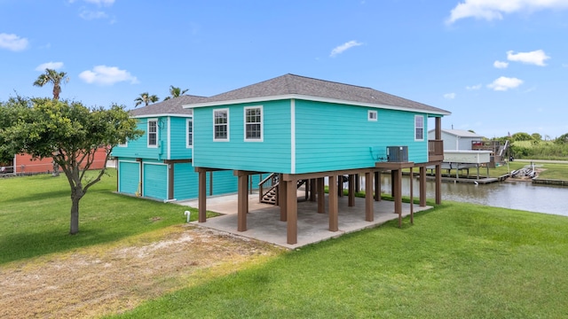 621 County Road 202, Sargent, TX 77414 - back of house with a carport, cooling unit, dirt driveway, a water view, and a patio area