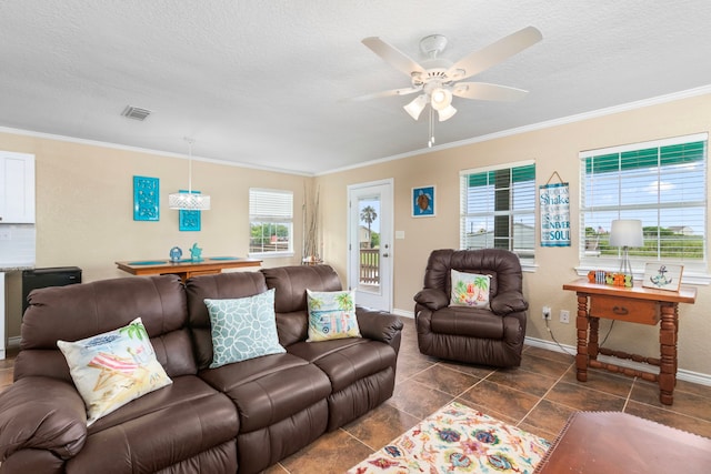 621 County Road 202, Sargent, TX 77414 - living area with baseboards, a ceiling fan, a textured ceiling, and crown molding