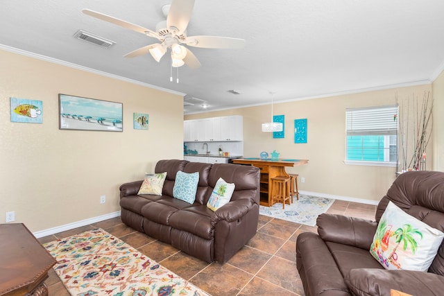621 County Road 202, Sargent, TX 77414 - living room featuring ornamental molding, ceiling fan, baseboards, and dark tile patterned floors