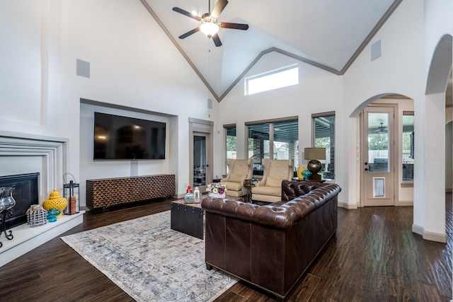 18815 Ellis Bend Dr, Cypress, TX 77433 - living area featuring ceiling fan, high vaulted ceiling, arched walkways, wood finished floors, and a glass covered fireplace