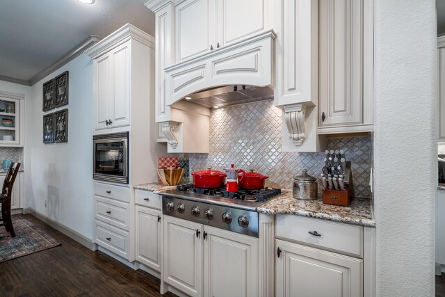 18815 Ellis Bend Dr, Cypress, TX 77433 - kitchen with built in microwave, stainless steel gas stovetop, premium range hood, tasteful backsplash, and dark wood-style flooring