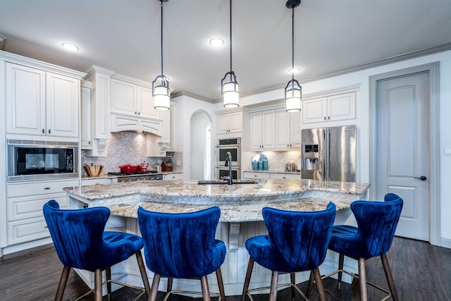 18815 Ellis Bend Dr, Cypress, TX 77433 - kitchen featuring stainless steel appliances, a sink, a large island with sink, white cabinetry, and crown molding