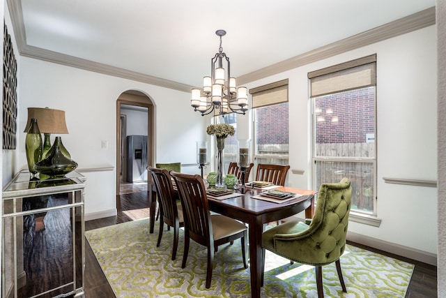 18815 Ellis Bend Dr, Cypress, TX 77433 - dining room featuring arched walkways, a chandelier, baseboards, crown molding, and dark wood finished floors