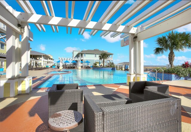 4123 King Rail Cir, Galveston, TX 77554 - community pool with a pergola and a patio area