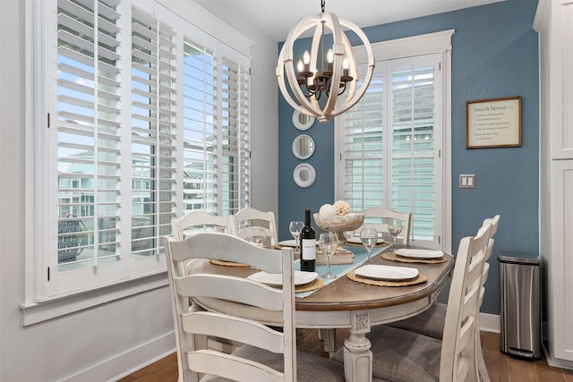 4123 King Rail Cir, Galveston, TX 77554 - dining room featuring a chandelier, plenty of natural light, wood finished floors, and baseboards