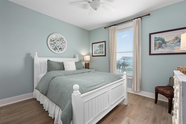 4123 King Rail Cir, Galveston, TX 77554 - bedroom with light wood-style floors, baseboards, and ceiling fan