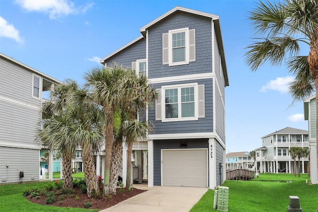 4123 King Rail Cir, Galveston, TX 77554 - coastal inspired home featuring a front lawn, driveway, and a garage