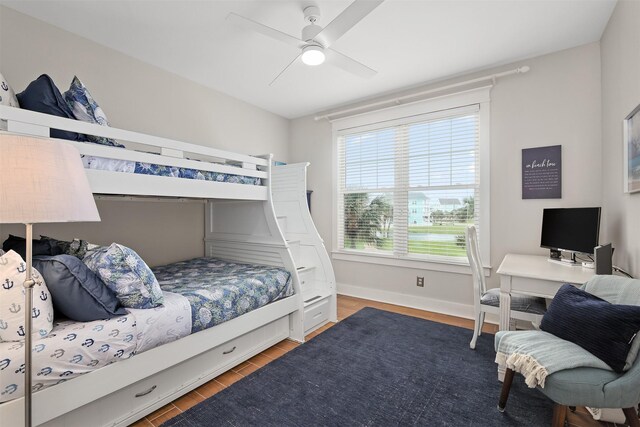 4123 King Rail Cir, Galveston, TX 77554 - bedroom featuring wood finished floors, an office area, a ceiling fan, and baseboards