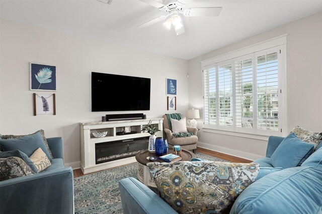 4123 King Rail Cir, Galveston, TX 77554 - living area with baseboards, wood finished floors, and ceiling fan