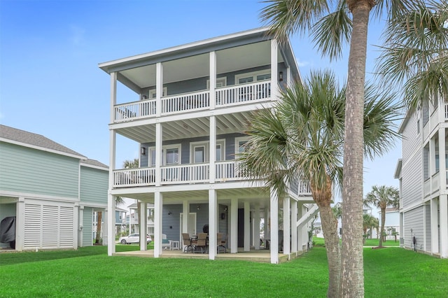4123 King Rail Cir, Galveston, TX 77554 - rear view of house featuring a yard and a balcony