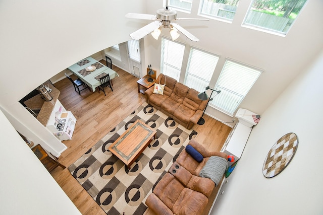 2818 Lakecrest Forest Dr, Katy, TX 77493 - living area with a high ceiling, a ceiling fan, and wood finished floors