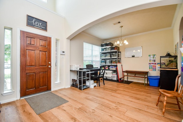 2818 Lakecrest Forest Dr, Katy, TX 77493 - foyer entrance with arched walkways, wood finished floors, a chandelier, ornamental molding, and baseboards