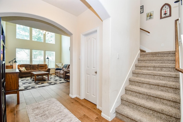 2818 Lakecrest Forest Dr, Katy, TX 77493 - staircase with arched walkways, wood finished floors, and baseboards