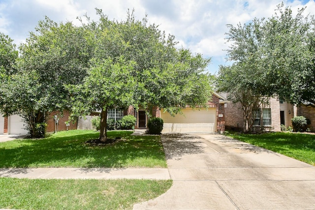 2818 Lakecrest Forest Dr, Katy, TX 77493 - view of property hidden behind natural elements with brick siding, a garage, driveway, and a front yard