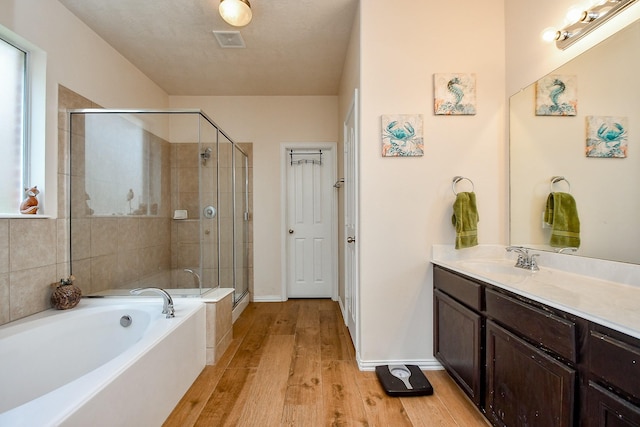 2818 Lakecrest Forest Dr, Katy, TX 77493 - full bath featuring a garden tub, vanity, a stall shower, wood finished floors, and baseboards