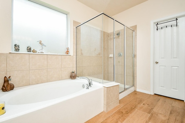 2818 Lakecrest Forest Dr, Katy, TX 77493 - bathroom featuring a garden tub, a shower stall, and wood finished floors