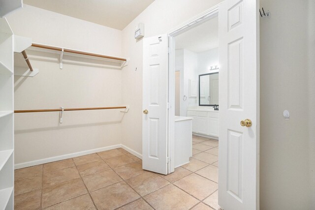 312 Cedar Branch Dr, League City, TX 77573 - spacious closet featuring light tile patterned floors and a sink