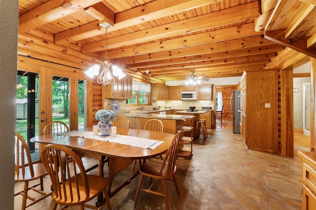 19314 Indigo Lake Dr, Magnolia, TX 77355 - dining room featuring light stone finish flooring, wood ceiling with exposed beams, a chandelier, and a ceiling fan