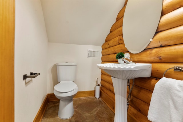 19314 Indigo Lake Dr, Magnolia, TX 77355 - half bathroom with toilet, baseboards, log walls, and lofted ceiling