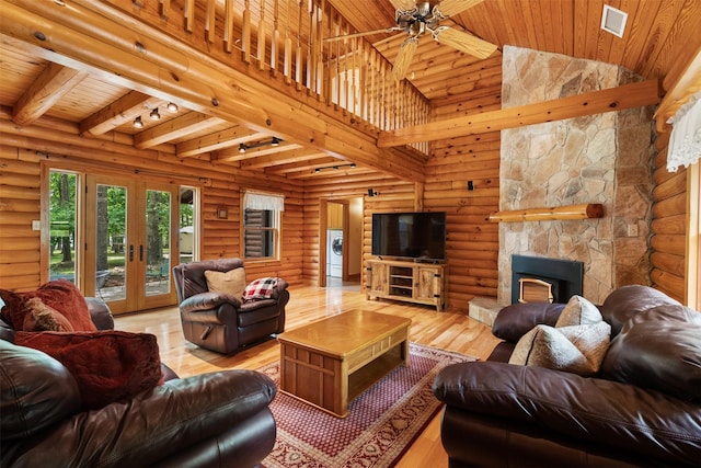 19314 Indigo Lake Dr, Magnolia, TX 77355 - living room with washer / clothes dryer, wooden ceiling, log walls, a ceiling fan, and a fireplace