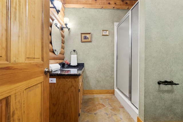 19314 Indigo Lake Dr, Magnolia, TX 77355 - full bath with a shower stall, vanity, baseboards, and stone finish flooring