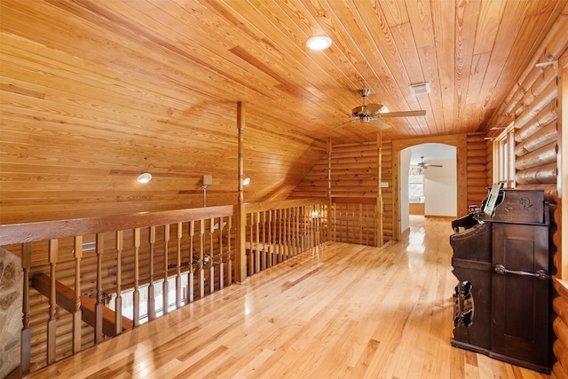 19314 Indigo Lake Dr, Magnolia, TX 77355 - hall with wooden ceiling, rustic walls, arched walkways, wood-type flooring, and an upstairs landing