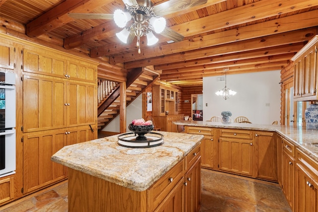 19314 Indigo Lake Dr, Magnolia, TX 77355 - kitchen with wood ceiling with exposed beams, a peninsula, a center island, a ceiling fan, and light stone countertops