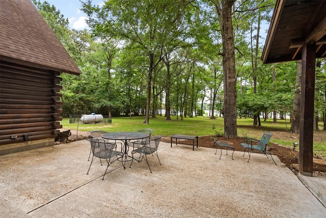 19314 Indigo Lake Dr, Magnolia, TX 77355 - view of patio / terrace with outdoor dining area and view of scattered trees