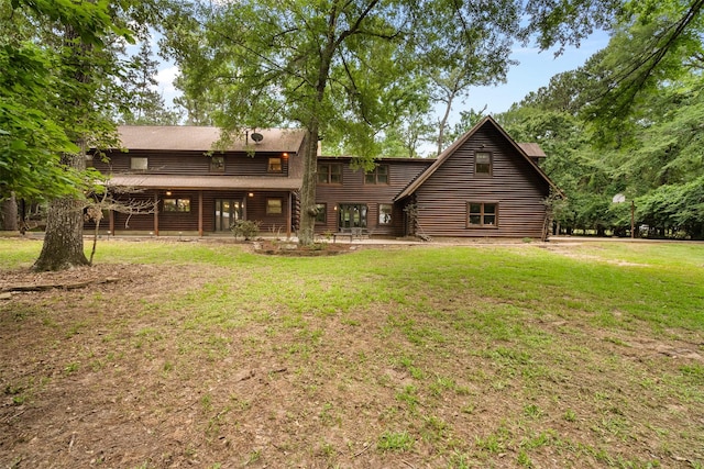 19314 Indigo Lake Dr, Magnolia, TX 77355 - back of house featuring a lawn