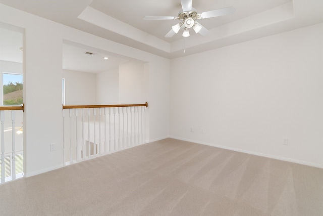 2113 Midway Ct, League City, TX 77573 - carpeted spare room featuring a tray ceiling, a ceiling fan, and baseboards