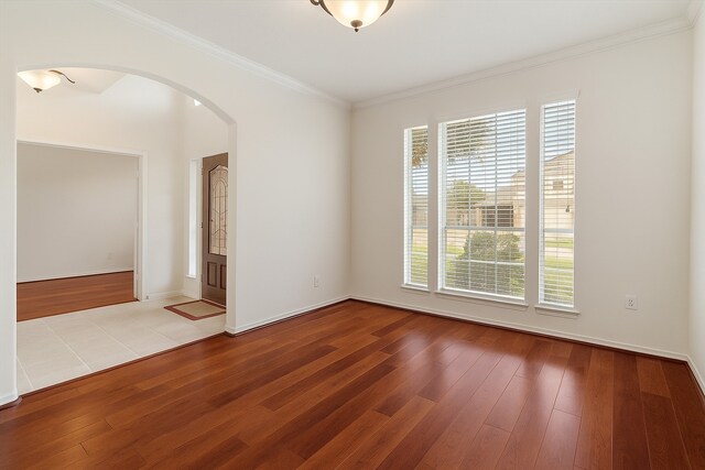 2113 Midway Ct, League City, TX 77573 - empty room featuring arched walkways, hardwood / wood-style floors, crown molding, and baseboards