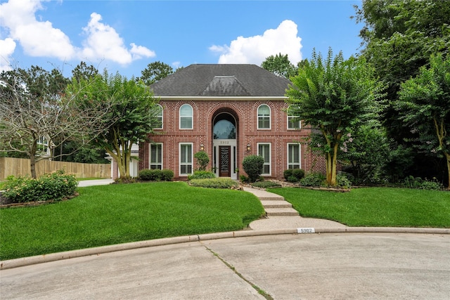 5902 Cardinal Creek Way, Kingwood, TX 77345 - georgian-style home featuring brick siding and a shingled roof