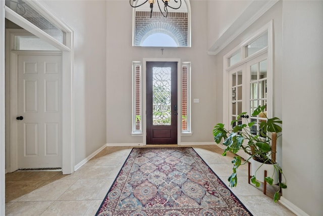 5902 Cardinal Creek Way, Kingwood, TX 77345 - entryway with a chandelier, a high ceiling, light tile patterned floors, healthy amount of natural light, and baseboards