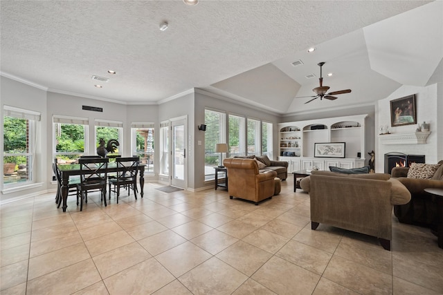 5902 Cardinal Creek Way, Kingwood, TX 77345 - living room with light tile patterned floors, built in shelves, a warm lit fireplace, a ceiling fan, and ornamental molding
