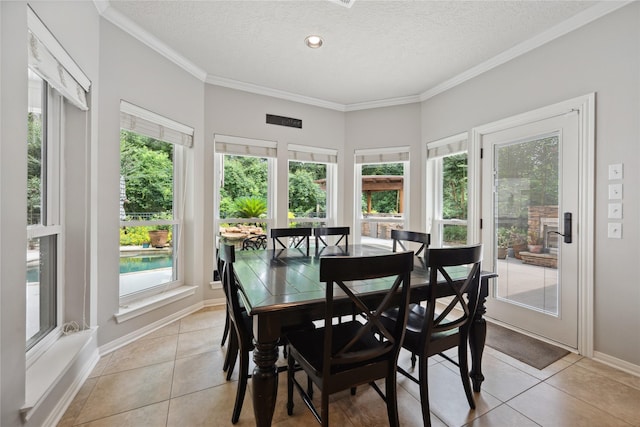 5902 Cardinal Creek Way, Kingwood, TX 77345 - dining room with light tile patterned floors, a textured ceiling, ornamental molding, and baseboards