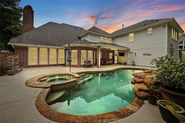 5902 Cardinal Creek Way, Kingwood, TX 77345 - pool at dusk featuring a patio and a pool with connected hot tub