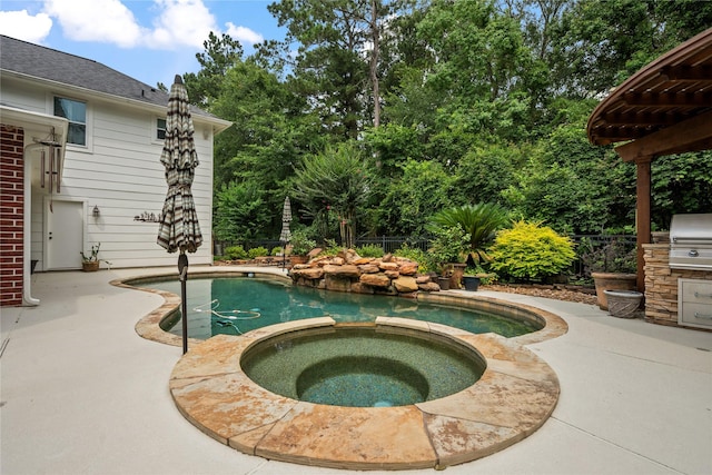 5902 Cardinal Creek Way, Kingwood, TX 77345 - view of pool featuring a pool with connected hot tub and a patio