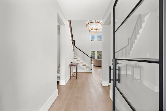 1610 Woodcrest Dr, Houston, TX 77018 - entryway with stairway, light wood-style floors, a chandelier, and baseboards