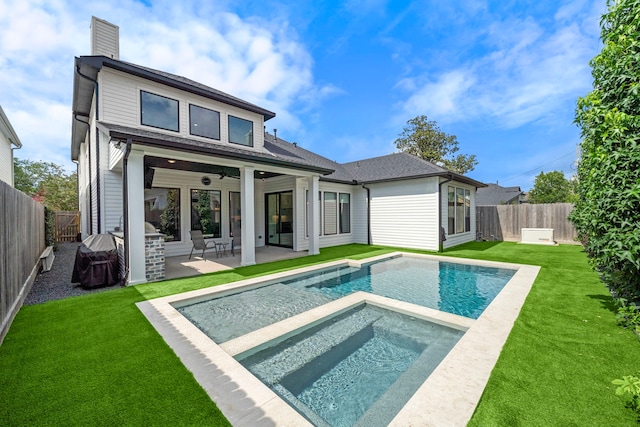 1610 Woodcrest Dr, Houston, TX 77018 - back of house with an in-ground hot tub, ceiling fan, a chimney, and a patio area