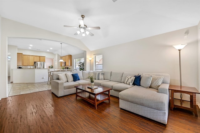 4506 Brazos Bend Dr, Pearland, TX 77584 - living area featuring lofted ceiling, ceiling fan, wood finished floors, and arched walkways