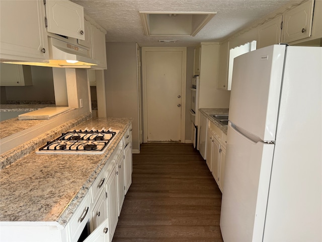 12819 Labelle Ln, Houston, TX 77015 - kitchen featuring white appliances, dark wood-type flooring, a textured ceiling, light countertops, and white cabinetry