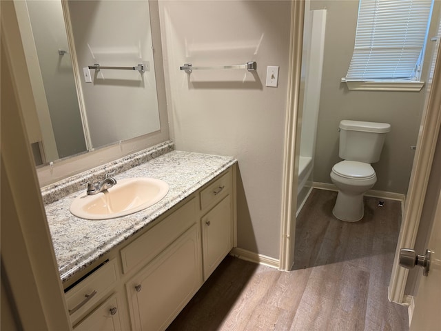 12819 Labelle Ln, Houston, TX 77015 - full bathroom featuring wood finished floors, vanity, toilet, and baseboards