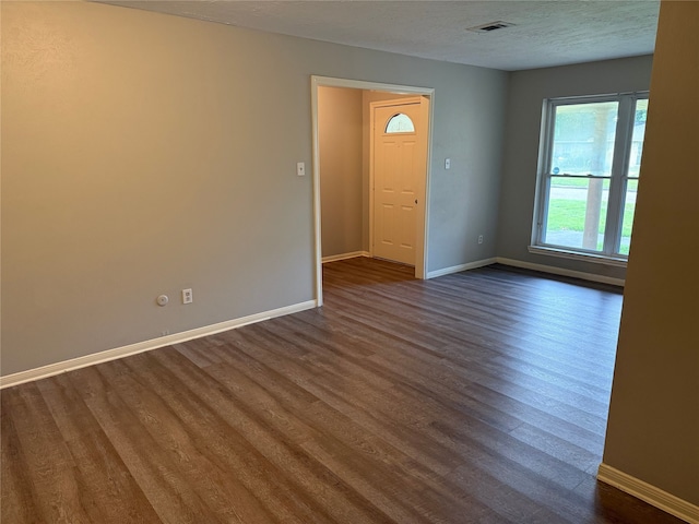 12819 Labelle Ln, Houston, TX 77015 - unfurnished room featuring dark wood-style floors, baseboards, and a textured ceiling