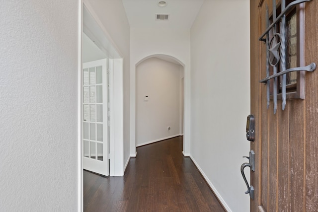 253 Dove Meadow Dr, Conroe, TX 77384 - foyer entrance featuring arched walkways, wood finished floors, and baseboards