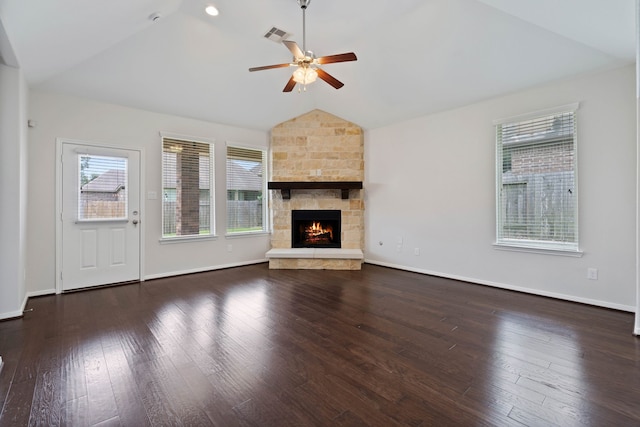 253 Dove Meadow Dr, Conroe, TX 77384 - unfurnished living room featuring vaulted ceiling, a ceiling fan, healthy amount of natural light, wood finished floors, and a stone fireplace