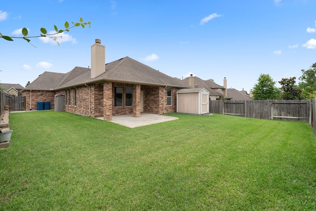 253 Dove Meadow Dr, Conroe, TX 77384 - back of property with a patio, brick siding, a chimney, and a shingled roof